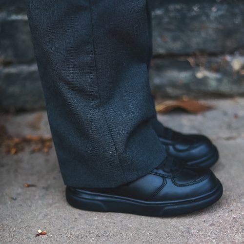 Grey trousers with black school shoe